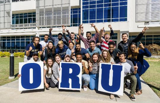 ORU students with sign
